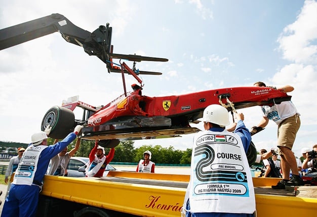 Felipe Massa's Ferrari is taken away on a flatbed truck following his accident during qualifying for the Hungarian Formula 1 Grand Prix. Image: Paul Gilham / Getty Images