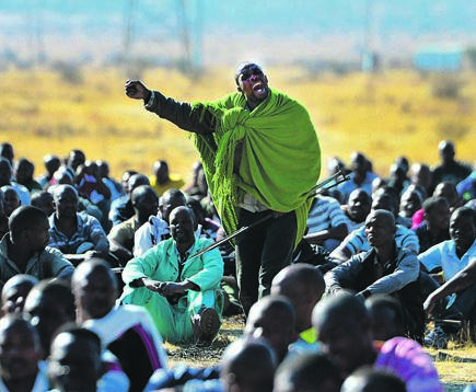 Strike leader Mgcineni Noki, also known as the man in the green blanket, rallies the mine workers at Marikana ahead of their encounter with police that left more than 35 dead. This picture is part of the exhibition. Picture: Leon Sadiki/City Press