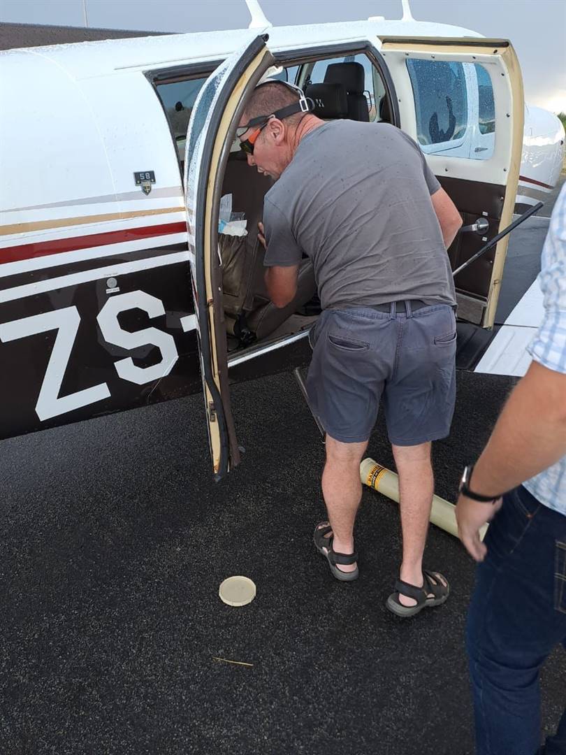Snake catcher, Johan de Klerk, is seen here looking for the highly venomous Cape cobra in the Beechcraft that had to make an emergency landing at the Welkom airport on Monday. Photo: Supplied