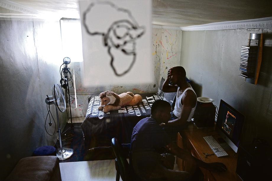 In the heat and confined space of a bedroom studio in Nyanga, Sibusiso and producer Nkululeko Gonya listen to sample recordings for future ventures. Picture: Ross Jansen