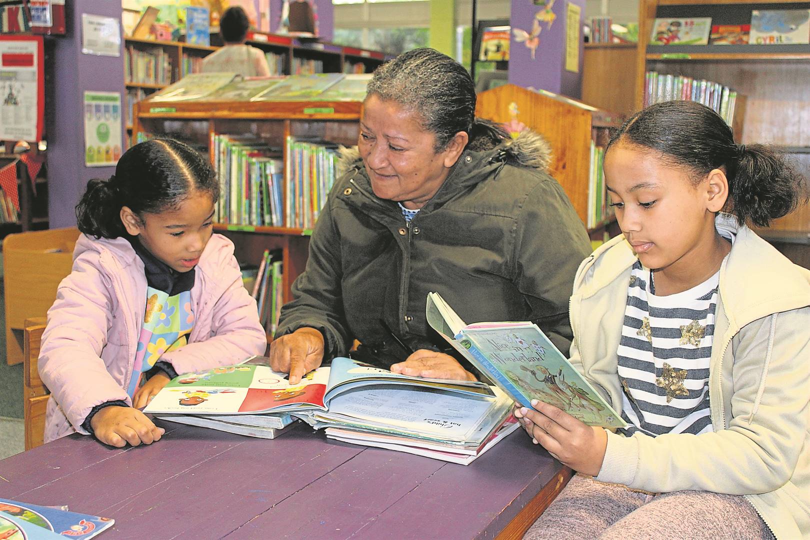 Millicent Fisher spends some time at Strand Library with her grandchildren, six-year-old Zahra Armien (left) and nine-year-old Laiqa Armien ahead of the SA Festival of Children’s Literature. Picture for illustration. Photo: Yaseen Gaffar