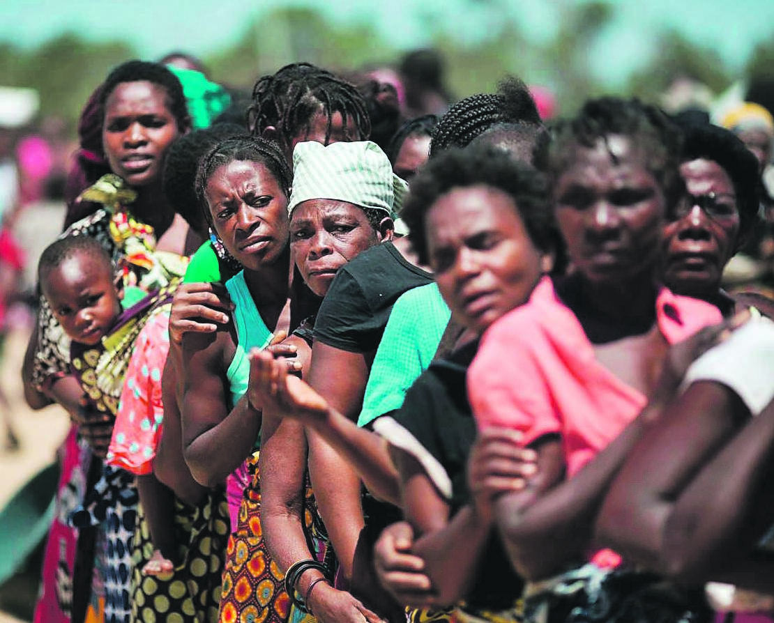 VIGILANT Women queue to receive aid in Nhamaibwe, Mozambique. Picture: John Estey / CARE
