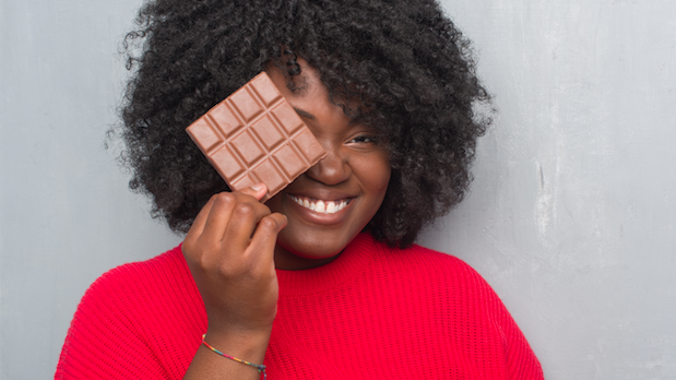 A woman holding dark chocolate