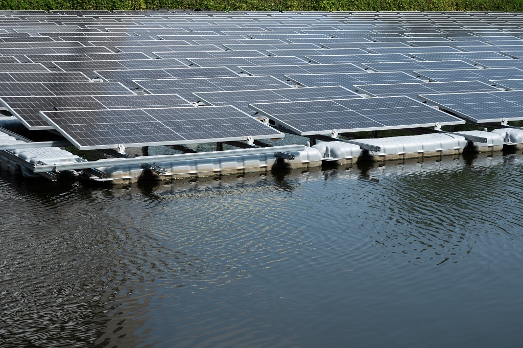 Solar panels containing photovoltaic cells float on water