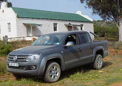 ANCIENT AND MODERN: VW's  new Amarok superbakkie, dusty from the trail, and an old farmer's cottage in the Baviaanskloof.
