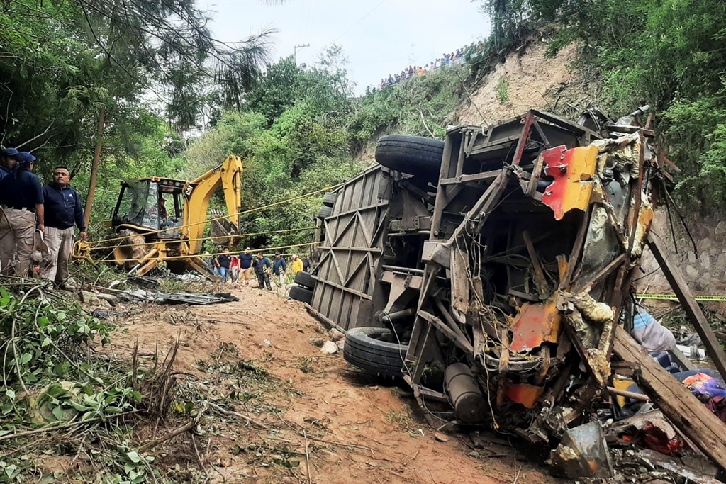 This handout picture released by the Tlaxiaco Municiapl Police shows the remains of a bus after it plummeted into a ravine in the outskirts of Magdalena Peñasco, Oaxaca state, Mexico on July 5, 2023. 
