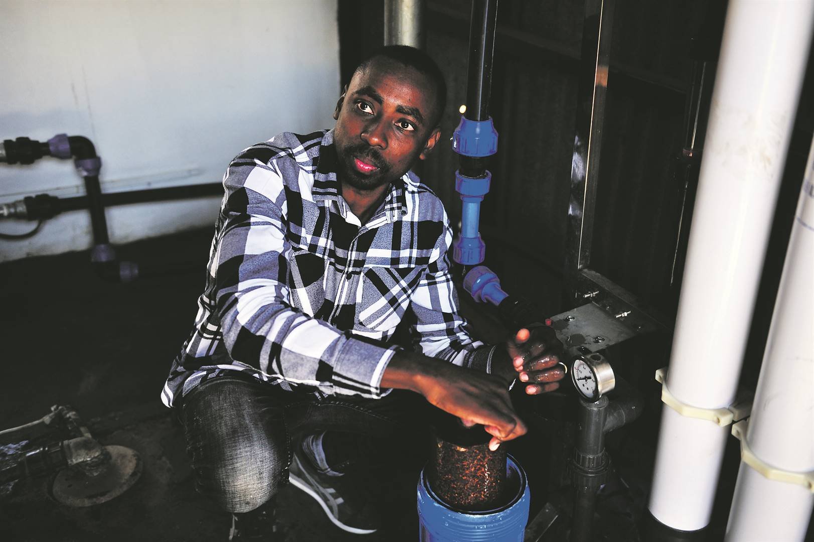 Murendeni Mafumo, founder of Kusini Water, with his purification plant Picture: Cebile Ntuli