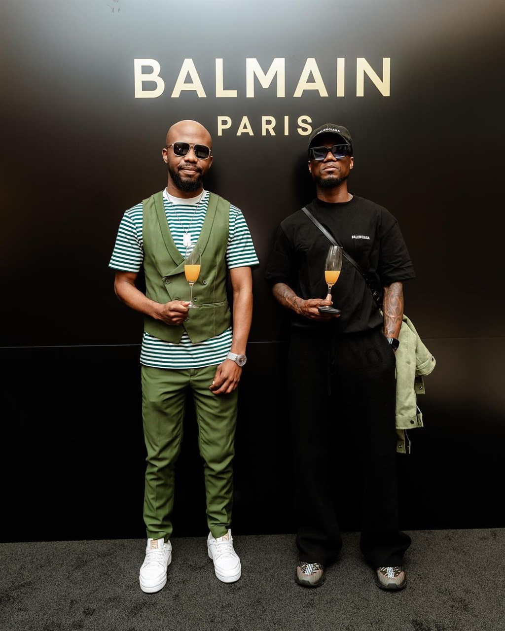 Teko Modise with a friend at the Balmain store opening in Sandton. 