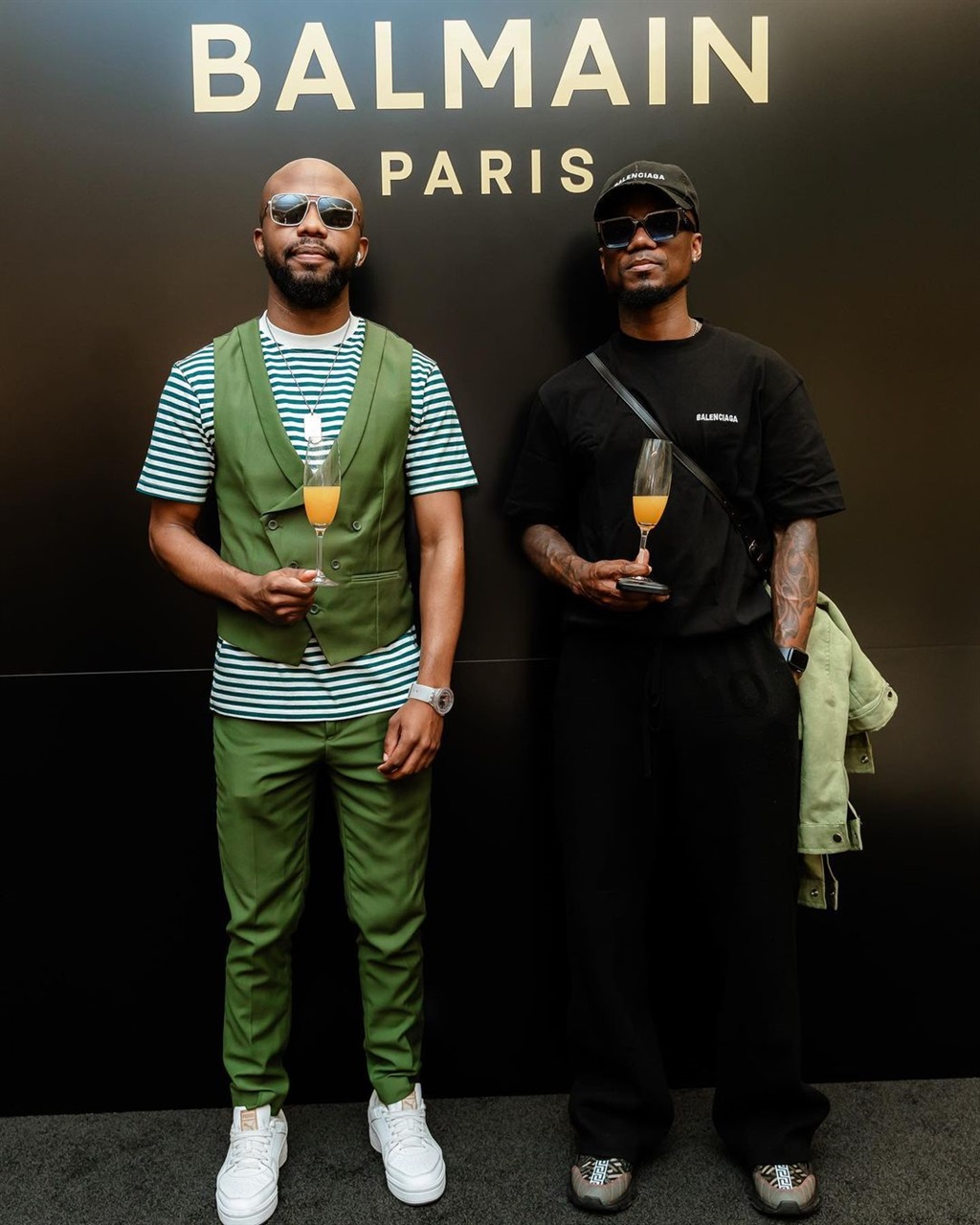 Teko Modise with a friend at the Balmain store ope