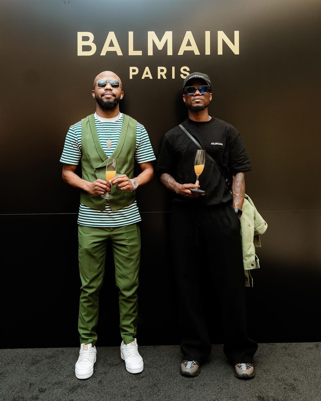 Teko Modise with a friend at the Balmain store ope
