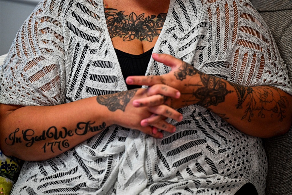 A covered tattoo is seen on the chest of sex traff