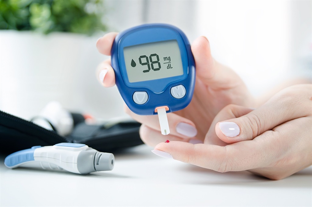 Diabetes checking blood sugar level. Woman using l