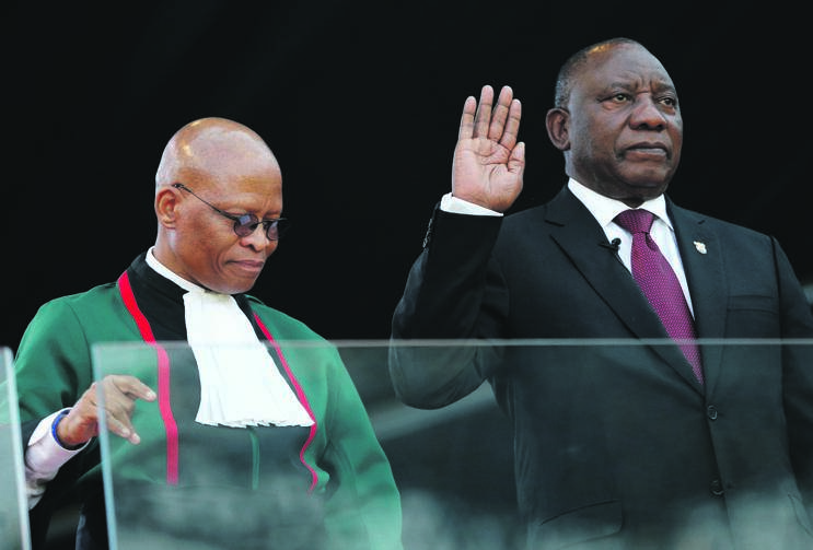 Chief Justice Mogoeng Mogoeng stands beside President Cyril Ramaphosa as he takes the oath of office at his inauguration at Loftus Versfeld Stadium yesterday. Picture: Siphiwe Sibeko / Reuters