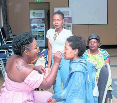 Mokgadi Moseri teaches young women how to apply make-up.Photo by Judas Sekwela
