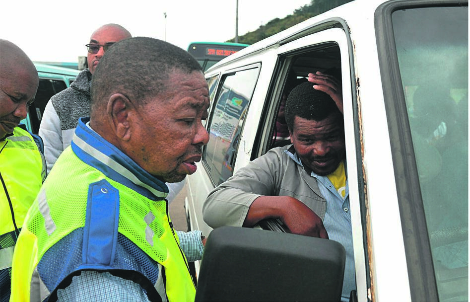 Minister of Transport Blade Nzimande checks Dumisani Dubazane’s taxi during a traffic inspection at Mariannhill toll plaza, west of Durban.    Photo by Jabulani Langa