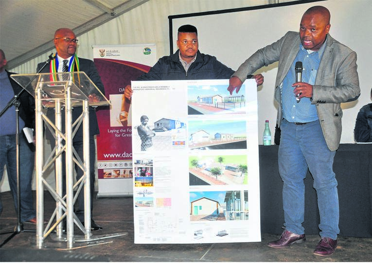 Arts and Culture Minister Nathi Mthetwa (left) introduces the contractors who will rebuild Winnie Mandela’s Free State house. Beckie Maseko explains the plans, while his partner Nico Motshwane holds them. Photo by Kabelo Tlhabanelo