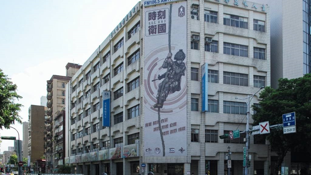 A big poster showing a soldier rappelling from a r