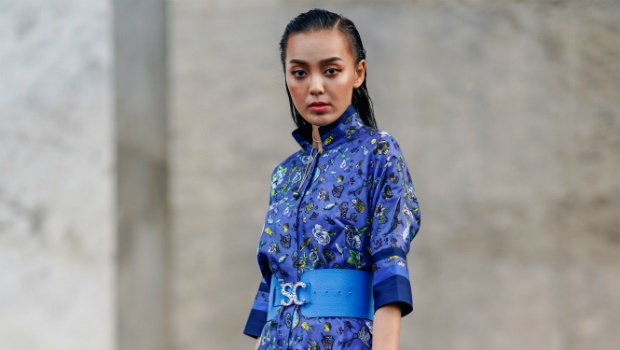  A guest wears a blue floral print dress during Paris Fashion Week 