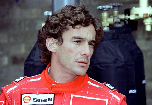 (FILES) In this file picture taken on May 1, 1994 Brazilian F1 driver Ayrton Senna adjusts his rear view mirror in the pits before the start of the San Marino Grand Prix in Imola, Italy. - May 1, 2019 marks the 25th anniversary of Ayrton Sennas death during the San Marino Grand Prix, raced at the Imola circuit in Italy. (Photo by JEAN-LOUP GAUTREAU / AFP)