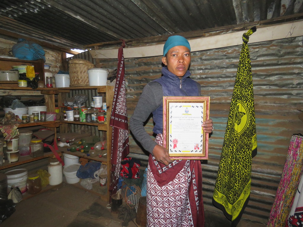 Sangoma Nikeziwe Mdlalose shows off her certificate from the Traditional Healers Organisation.
