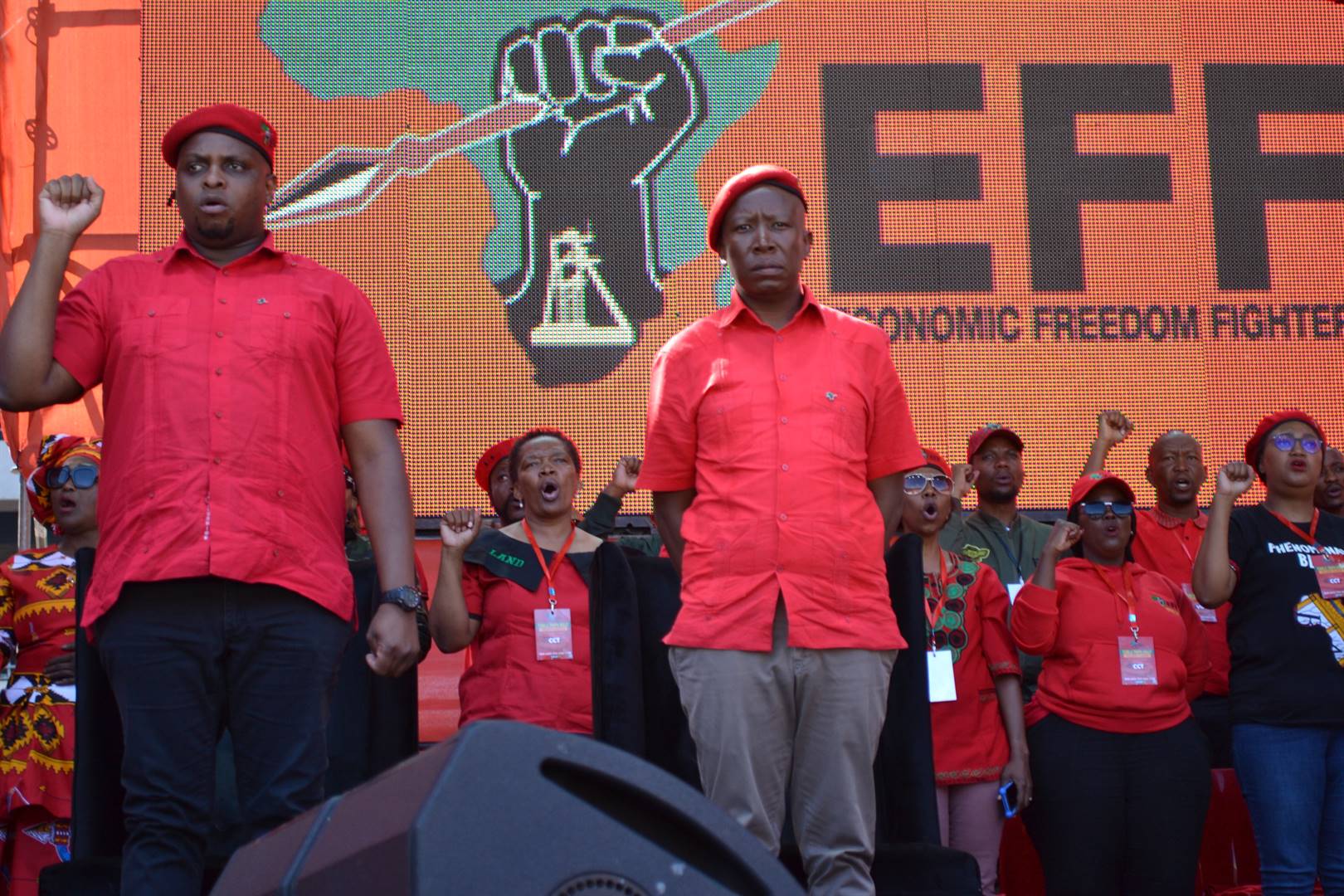 Julius Malema (right) and Floyd Shivambu (left) stand as the South African national anthem is sung at the EFF Tshela Thupa Rally at Orlando Stadium. Picture: Palesa Dlamini/ City Press