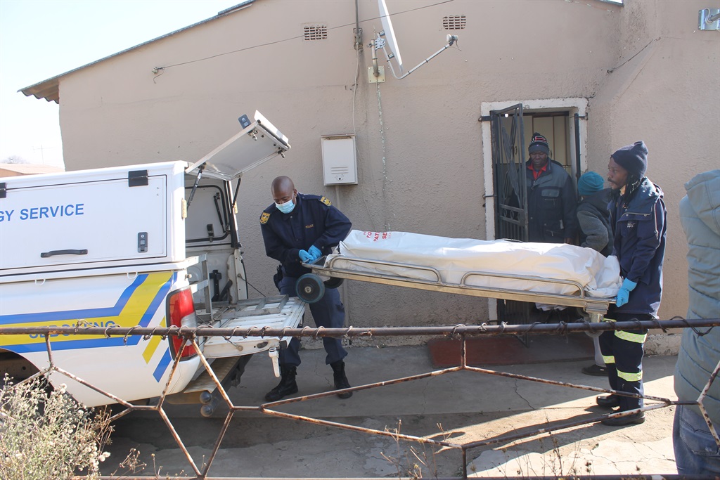 Tshegofatso Machobane's body being loaded into a mortuary van. Photo by Tumelo Mofokeng