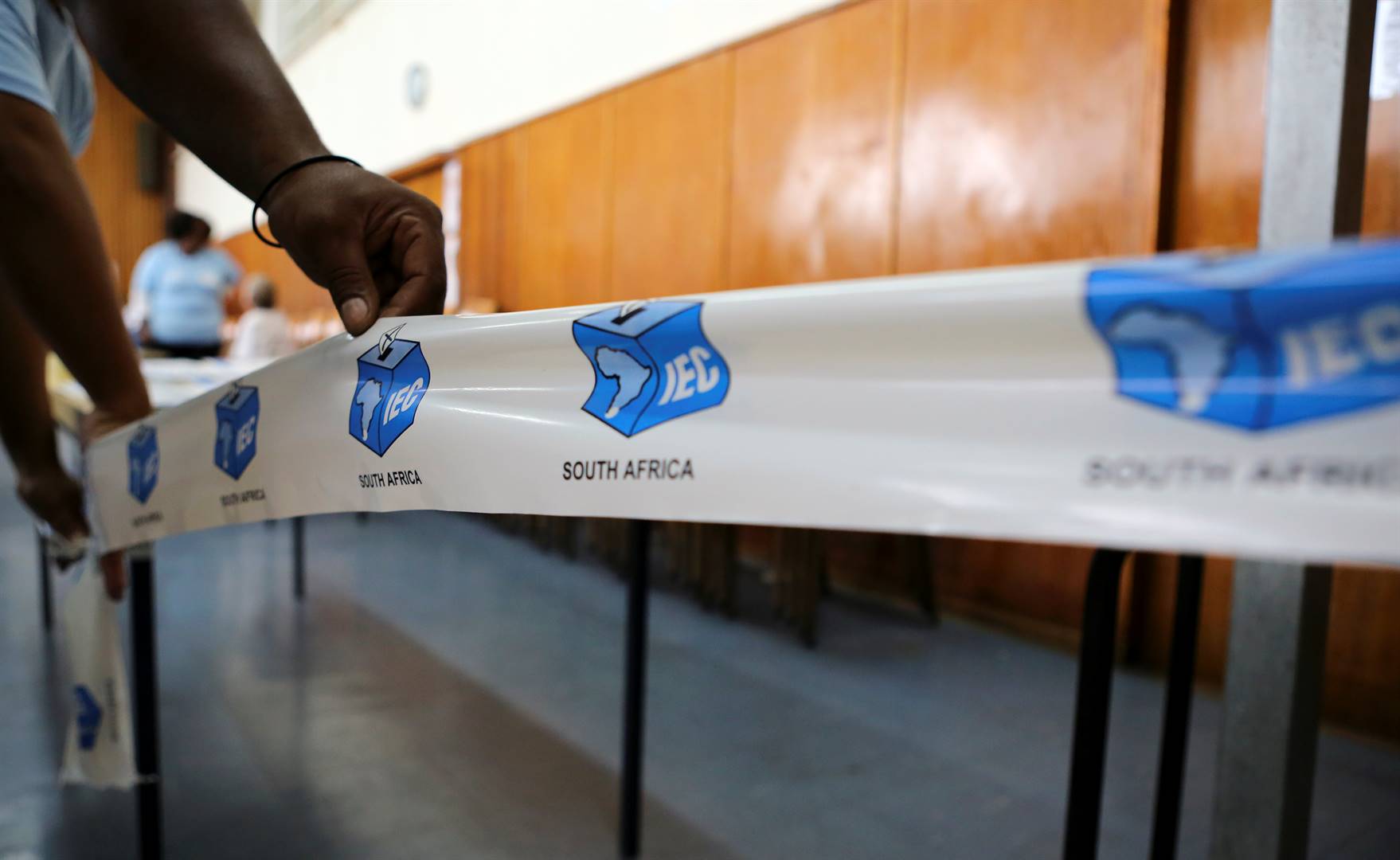 An election official sets up tape during preparations for the elections at a voting station in Cape Town. Picture: Sumaya Hisham/Reuters