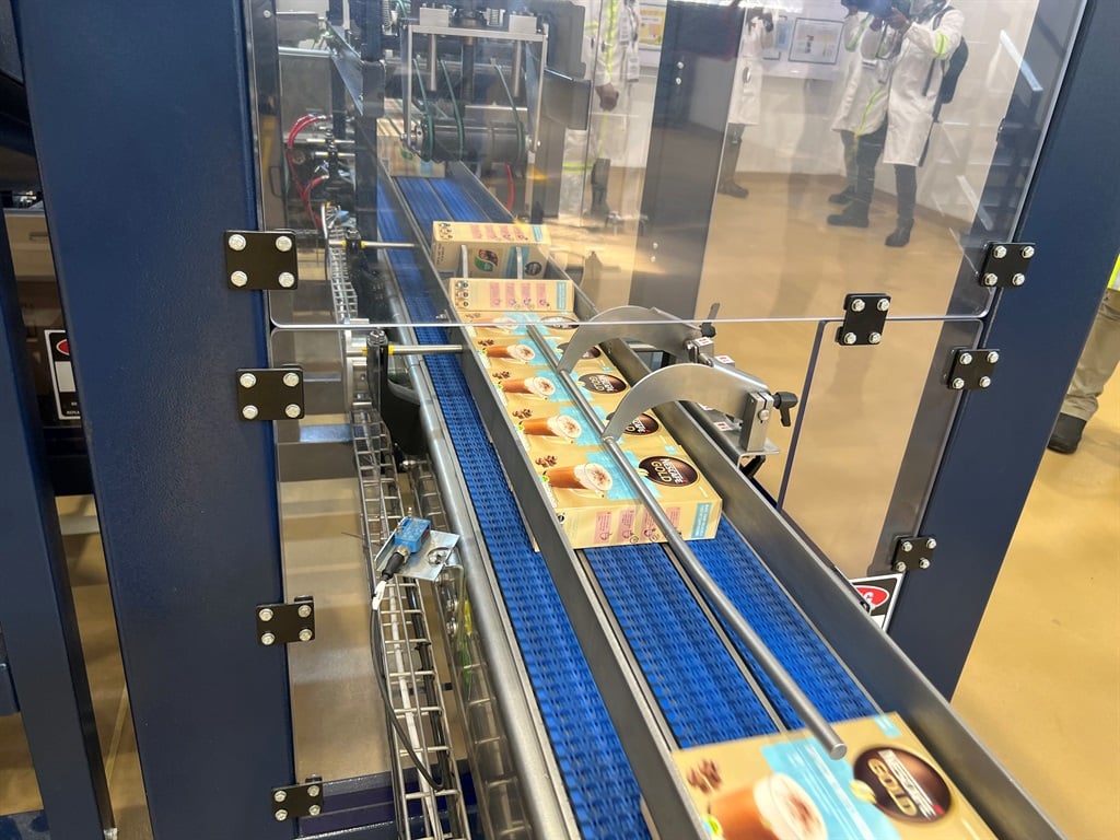 Nestlé coffee mixes packaged into boxes by automated machines.