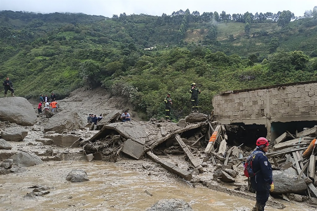 Rescue teams with drones searched for survivors on Tuesday after a landslide triggered by heavy rains left at least eight people dead and some eleven missing in central Colombia.