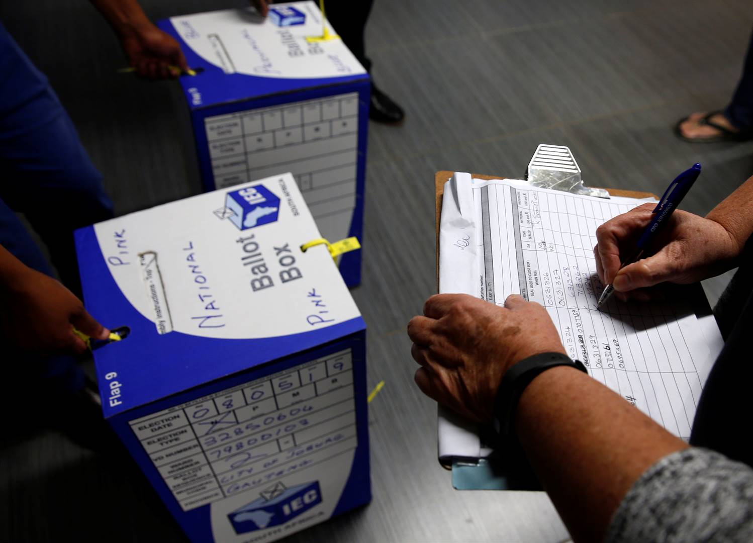 Election officials seal ballot boxes at the end of voting at a polling station in Johannesburg last night. Counting is under way – just over a quarter of the votes have been counted. Picture: Philimon Bulawayo/Reuters