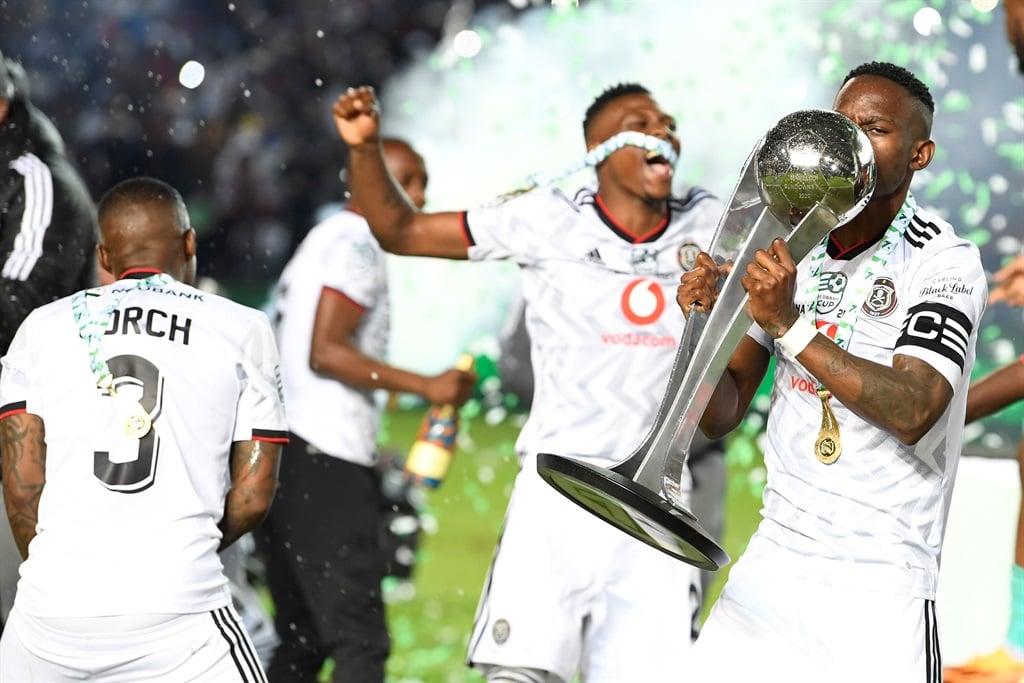 Orlando Pirates captain Innocent Maela lifts the Nedbank Cup Trophy with teammates  during the Nedbank Cup final match between Orlando Pirates and Sekhukhune United at Loftus Versfeld Stadium on March 27, 2023 in Pretoria, South Africa. 