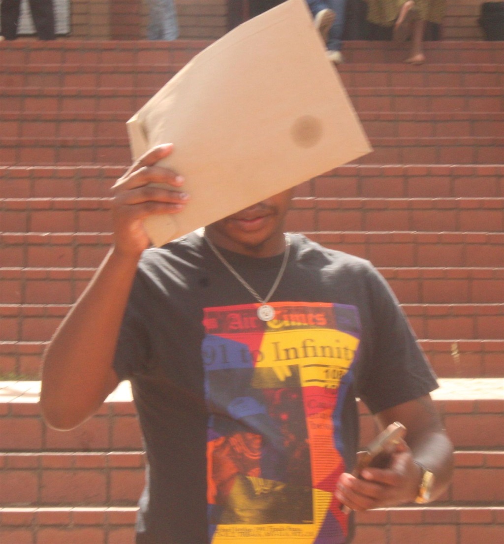 Comedian, Stopnonsons hides his face from the media after his appearance in the Randburg Magistrates Court on Monday, 19 February. Photo by Phuti Mathobela