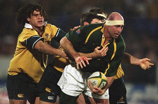 Mark Andrews of South Africa is tackled by George Smith (left) and Daniel Herbert of Australia during the 2001 Tri-Nations match between South Africa and Australia at Loftus Versfeld in Pretoria on 28 July 2001.