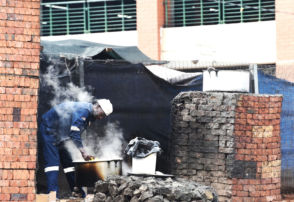 A street hustler cooking near Bree Taxi Rank. Phot