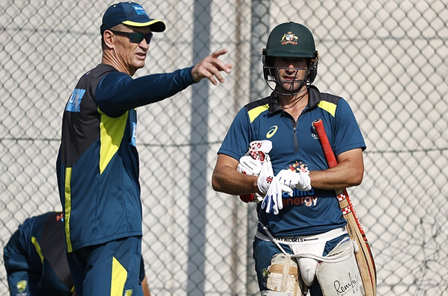 Australian batting coach Graeme Hick speaks with Joe Burns during a net session at The Gabba in Brisbane on 19 November 2019.