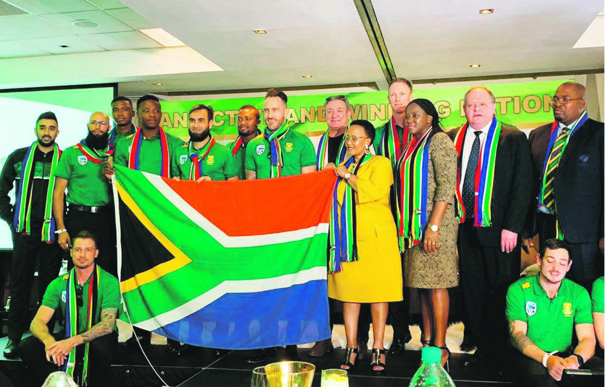 Sports Minister Tokozile Xasa holds the national flag alongside the Proteas and sports officials. The cricket team is just one of our national squads playing in World Cups this year. The ‘cup run’ starts with the Fifa Under-20 World Cup on Thursday and ends with the Springboks playing in Japan in September Picture: Supplied