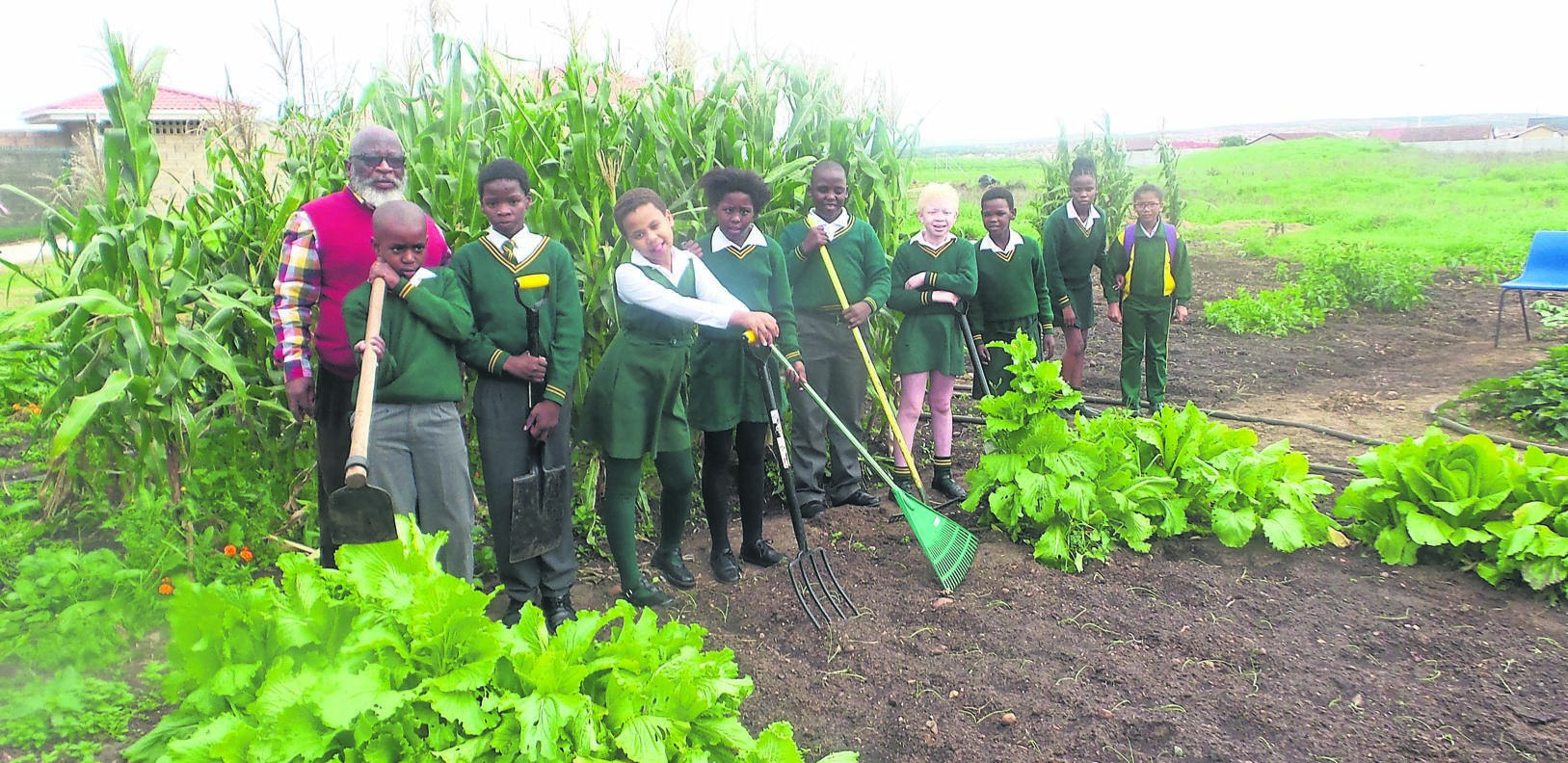 Left: Deputy principal Alec Stoffels of Khanyisa School for the Blind helps school kids look after their vegetable garden.               Photo byJoseph Chirume