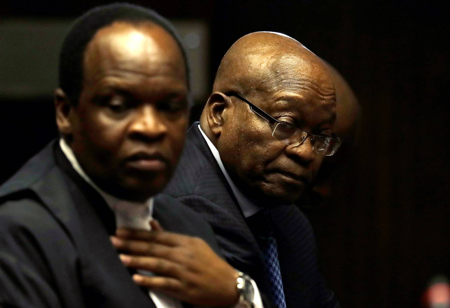 Jacob Zuma sits beside members of his legal team in court in Pietermaritzburg. He faces charges that include fraud, corruption and racketeering. Picture: Themba Hadebe/Reuters