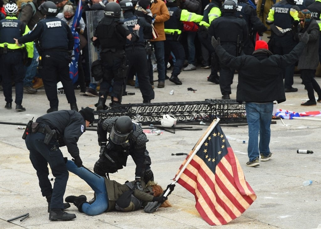 Police detain a person as supporters of US Preside