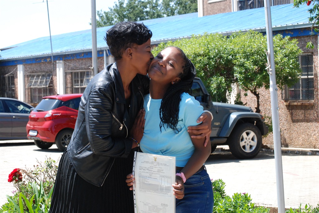 Top achiever Busisiwe Mahlangu being congratulated by her geography teacher Lindokuhle Kambule. Photo by Khaya Masipa