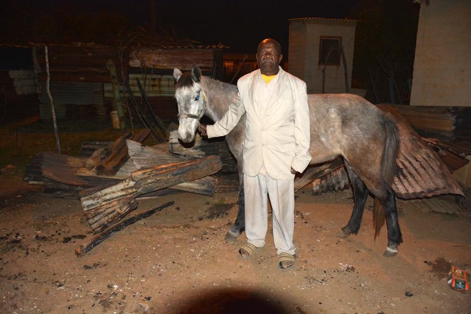 Moses Mthombeni and his horse, which was saved by cops. Photo by Muntu Nkosi