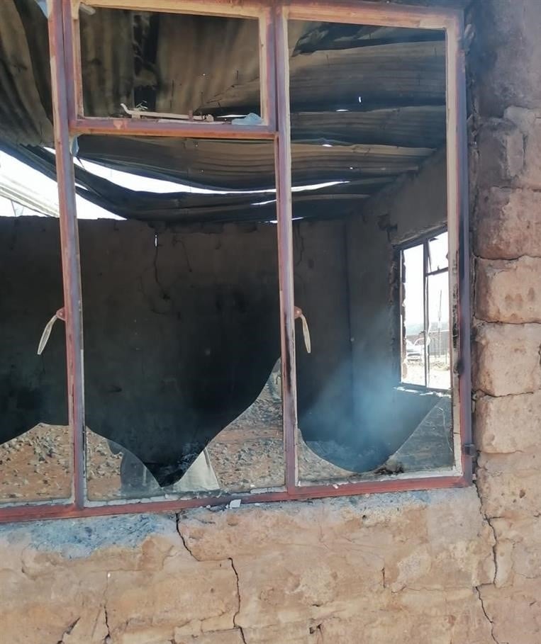 A fuming mob burnt down two houses over allegations of poisoning. 