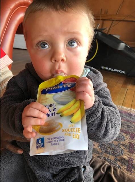 Sometimes Sebastian, now 8 months, grabs the pouch and tries to feed himself!. Picture: Grethe Kemp/City Press