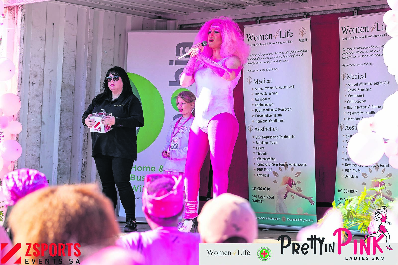 MC Lola le Roux leading the handout of lucky draw prizes.                                     