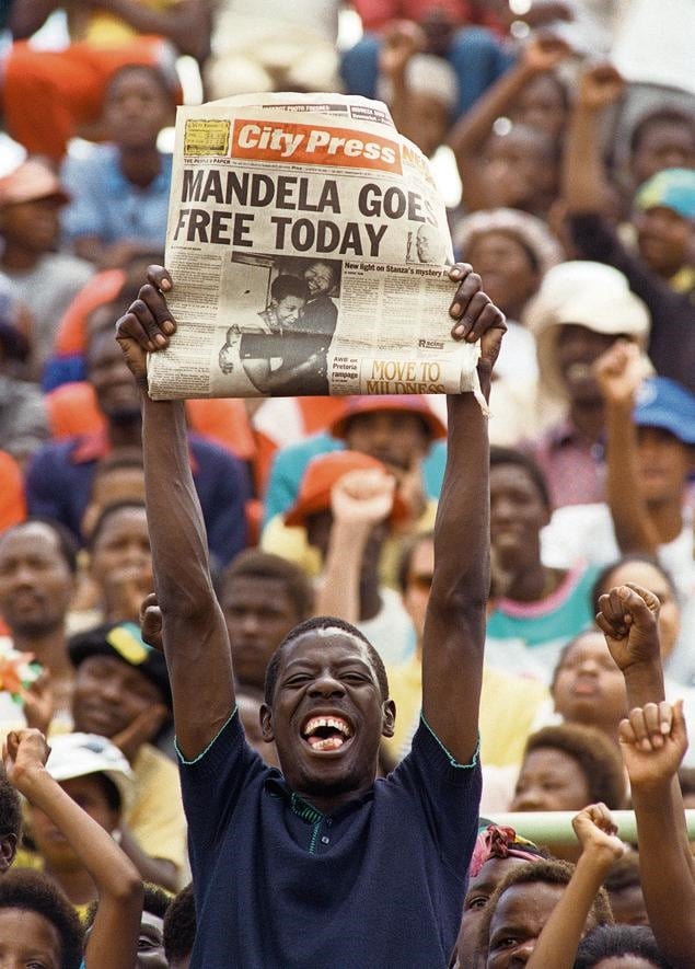 A jubilant Sowetan holds up a newspaper announcing the release of anti-apartheid leader and ANC member Nelson Mandela at a mass ANC rally on February 11 1990. At the opening of Parliament on February 2, South Africa’s then president FW de Klerk lifted the 30-year-old ban on the ANC and the SA Communist Party. And, on February 11, Mandela walked out of Victor Verster prison, near Cape Town, 27 years after he had been sentenced to life imprisonment. Picture: FP