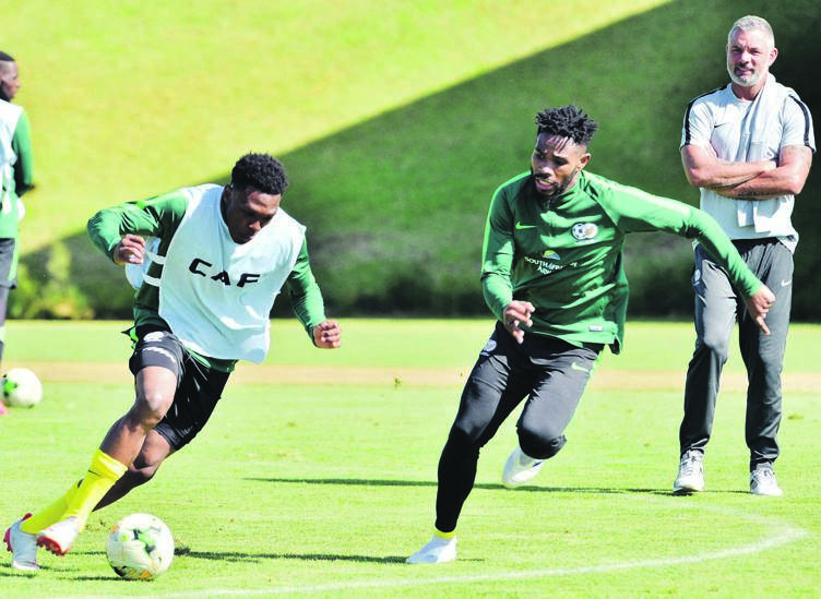 Thulani Hlatshwayo (right) tackles Lebo Mothiba, as Mark Fish watches on during Bafana Bafana’s training session in Steyn City, Joburg yesterday.Photo by     Lucky Morajane
