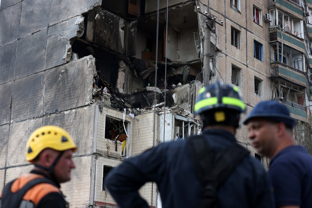Rescuers work outside a nine-storey residential bu