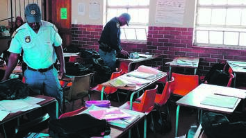 Police search a classroom at Westpark Primary School on Friday where they discovered a screw driver and cigarette lighter.