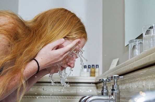 Woman washing her face (Photo by Universal Images 