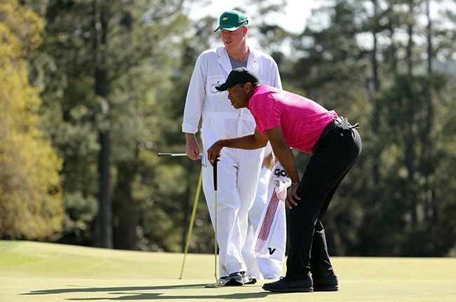 Tiger Woods lines up a putt at the Masters. (Photo by Jamie Squire/Getty Images)